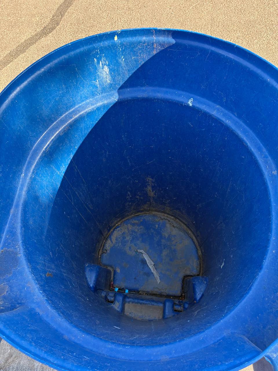 Before: dirty blue trash bin interior with grime and residue